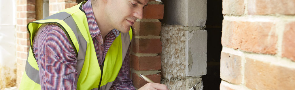 Man inspecting home walls